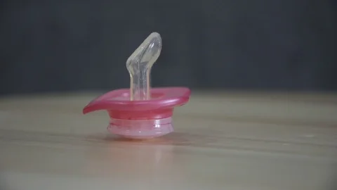 Pink orthodontic pacifier isolated Stock Footage 107332427
