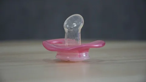 Pink orthodontic pacifier isolated  Stock Footage 107332461
