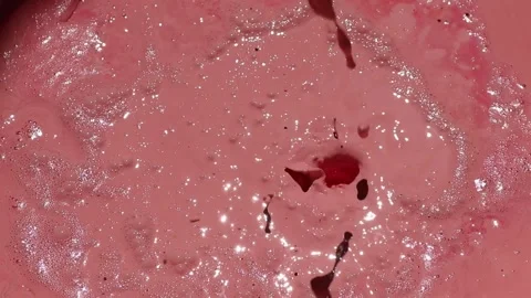 Pink paint liquid splash with bubbles. Stock Footage 161792161