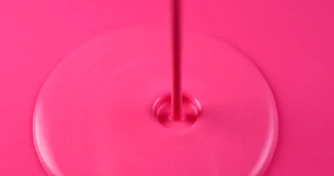 Pink paint pouring on pink surface in slow motion. Filmed with RED camera. Stock Footage 153663637