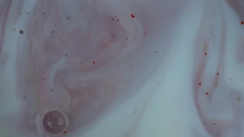 Pink pale paint stains on a white background. Ink is spreading. Video Stockbeeldmateriaal 123777919