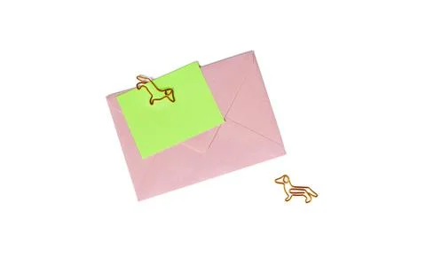 Pink paper envelope with blank note and dog-shaped paper clip on white backgr Stock Photos