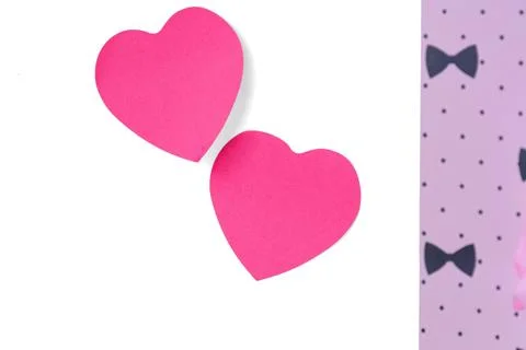 Pink paper heart shapes with patterned fabric on white background Stock Photos