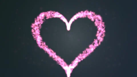 Pink particles dynamically form a romantic heart shape Stock Footage 327338517