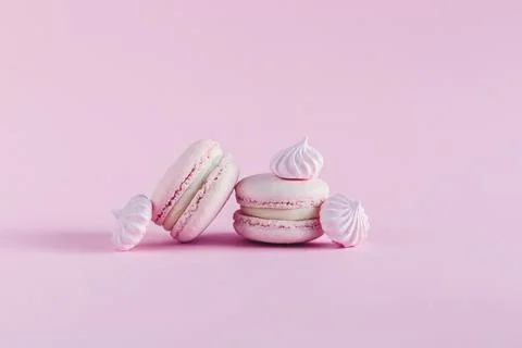 Pink pastel macarons with marshmallows on a pink pastel background. Place for Stock Photos