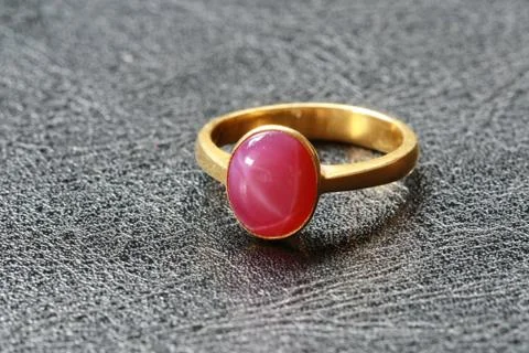 Pink pebble on gold ring Stock Photos