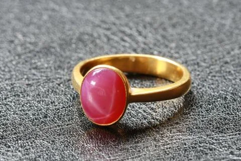 Pink pebble on gold ring Stock Photos