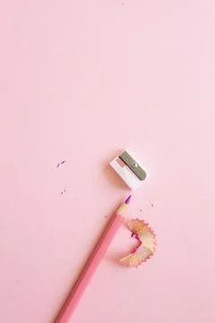 Pink pencil with sharpener on light pink background Stock Photos