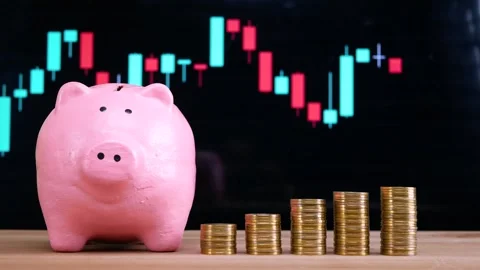 Pink piggy bank and stack of golden money coin on wooden desk Stock Footage 281140462