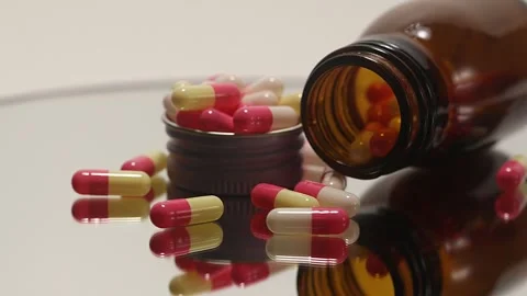 Pink pills on a turntable Stock Footage 249972760