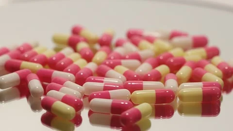 Pink pills on a turntable Stock Footage 249973051