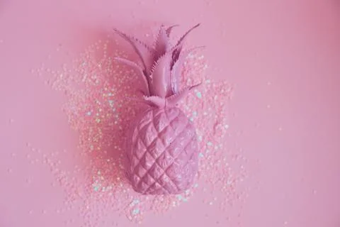 Pink pineapple lying in glitters. Concept minimal photo. Top view Stock Photos