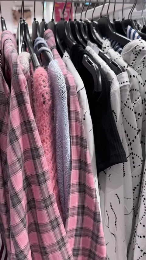 Pink Plaid Jackets And Striped Garments Hanging On Clothing Rack Stock Footage 344977654