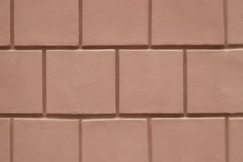 Pink plastered wall featuring a square pattern texture Stock Photos