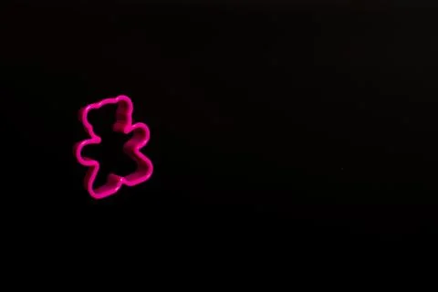 Pink plastic cookie cutter for making cookies in the shape of a teddy bear on Stock Photos