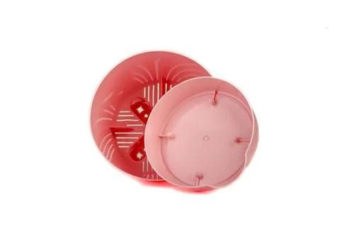 Pink plastic empty flower pot with tray on white background. Stock Photos