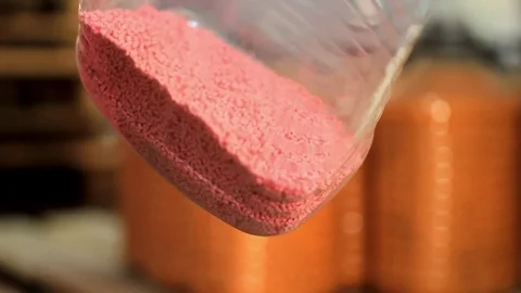 Pink plastic in granules in a bottle Video stock 76950983