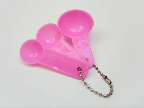 Pink Plastic Measuring Spoons Set Isolated on White Background Stock Photos