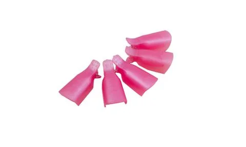 Pink plastic protective caps for nails isolated on a white background. Tools  Stock Photos