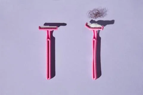 Pink plastic razor concept Stock Photos