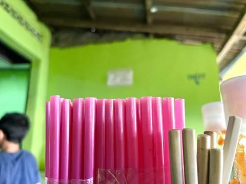 Pink plastic straws on a table for drinking Stock Photos