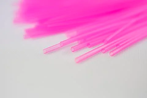 Pink plastic straws for use with drinks such as soft drinks, juices and alcoh Stock Photos