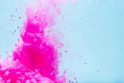 Pink powder explosion with blue background for art and design Stock Photos