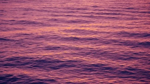 Pink purple sunset afterglow reflecting of the sea waves Stock Footage