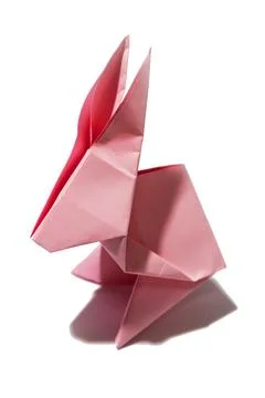 Pink rabbit shape paper on white background Stock Photos
