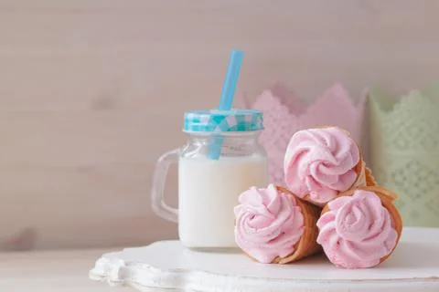 Pink raspberry flavour marshmallows or zephyr with milk on the wooden backgro Stock Photos
