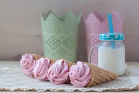 Pink raspberry flavour marshmallows or zephyr with milk on the wooden backgro Stock Photos