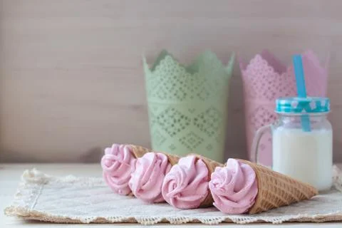 Pink raspberry flavour marshmallows or zephyr with milk on the wooden backgro Stock Photos