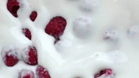 Pink raspberry floating dessert closeup. Summer berries milk yoghurt breakfast 動画素材 219268811
