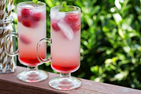 Pink raspberry lemonade in tall glasses Stock Photos