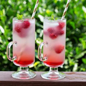 Pink raspberry lemonade in tall glasses Stock Photos