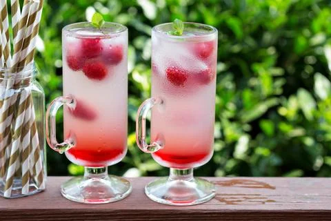 Pink raspberry lemonade in tall glasses Stock Photos