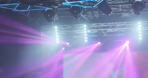 Pink rays motion of spotlights light in nightclub. Show illuminated with bright Stock Footage 253382877