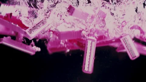 Pink Razers Drop and Float in Water Stock Footage 300892444