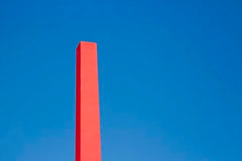 Pink rectangular chimney with blue sky 스톡 사진