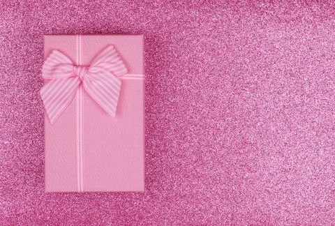 Pink rectangular gift box with pink ribbon on pink background. gift for March 8 Foto stock