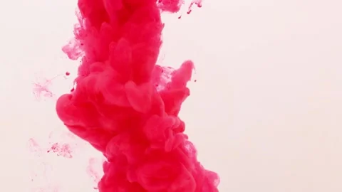 Pink red paint explodes and sprays in the water on a white background Stock Footage 154374565