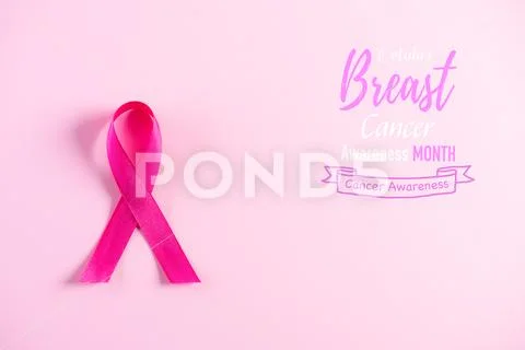Photograph: Pink ribbon on pink pastel paper background for