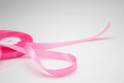 Pink ribbon scroll on white background. Breast Cancer Awareness Concept. Stock Photos