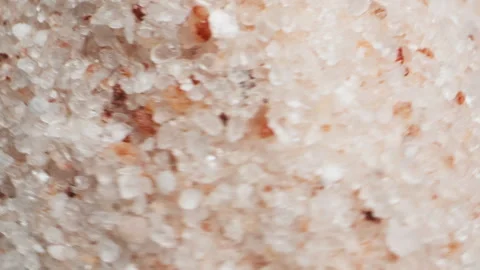 Pink salt close-up macro. Spice for food. Sea salt for bath. Man hand srewing Stock Footage 260760455