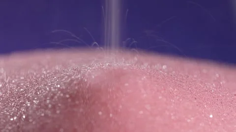 Pink sand falling and piling up at the base. Stock Footage 322143455