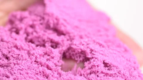 Pink sand is pouring from hands, macro shot. Close-up view woman's hands wi.. Stock Footage 278391071