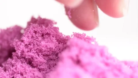 Pink sand is pouring from hands, macro shot. Close-up view woman's hands wi.. Stock Footage 280584361