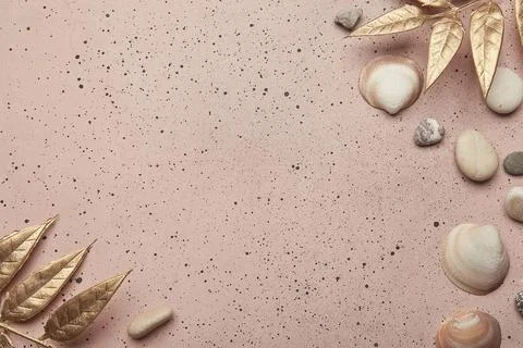 Pink sandy texture with seashells, pebbles for a summer background with copy Stock Photos