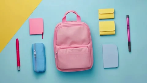 Pink School Backpack and Supplies on Colorful Background Stock Footage 279877204