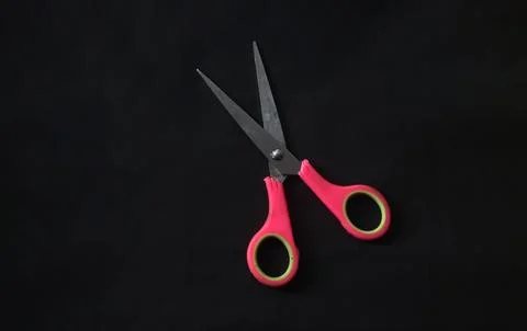 Pink scissors isolated on black background Stock Photos
